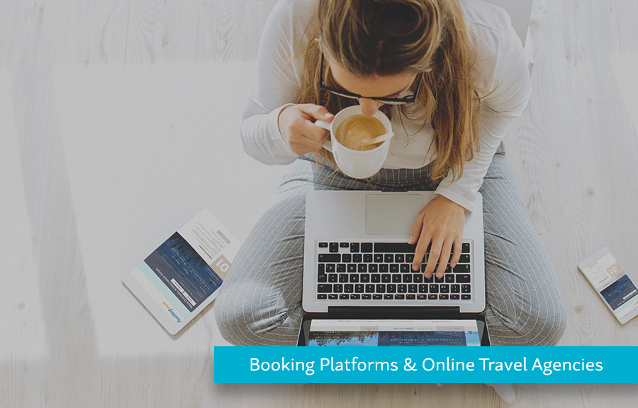 Woman drinking coffee while using a computer demonstrating how Hyperwallet helps Booking Platforms & Online Travel Agencies